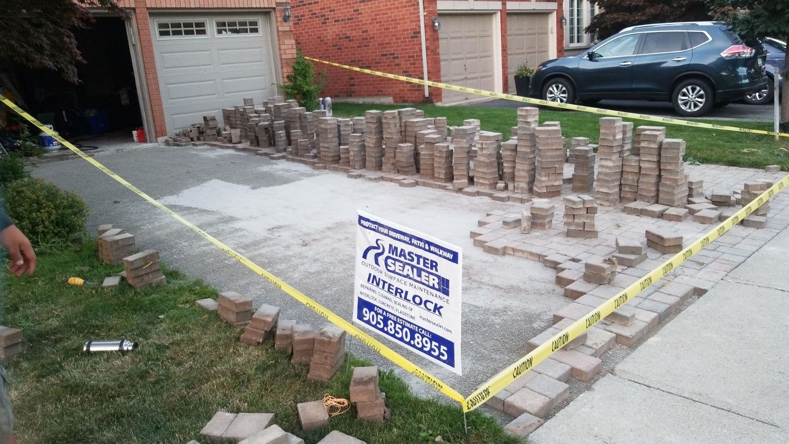 driveway interlock repair vaughan, removing the stones and relevelling the base, compacting and then relaying them